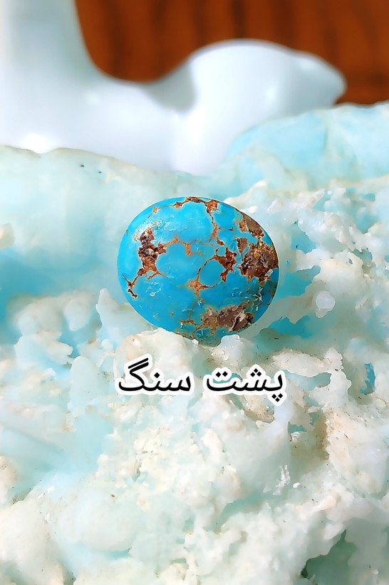 سنگ فیروزه عجمی نیشابوری، ذات عالی عجمی رگه دار (با نقش سگ عاشق و زن رقصنده)، بسیار خوشرنگ و خوش نقش و نگار، رنگ کمیاب و جذاب آبی محک، جلای فوق العاده درخشان و آینه ای با پودر الماس، تراش بیضی دامله مغزدار و تمام فیروزه با خلوص بالا، مناسب برای کار روی طلا، انگشتر، دستبند و مدال، با ضمانت اصل نیشابور، زنده و طبیعی.